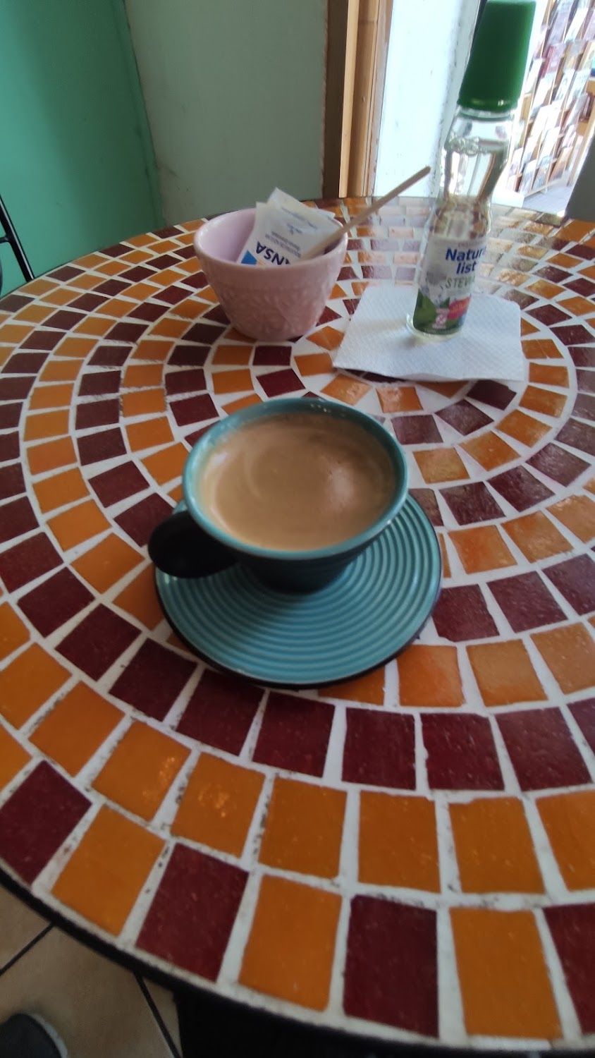 Taza verde servida sobre la mesa de mosaico